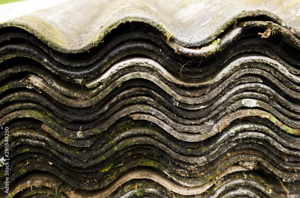 Stack of old asbestos slate roof sheets, wave pattern