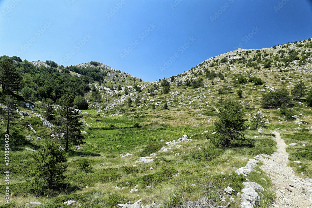 Path to the mountain tops of Biokovo with small field on the left Path to the mountain tops of Biokovo with small field on the left