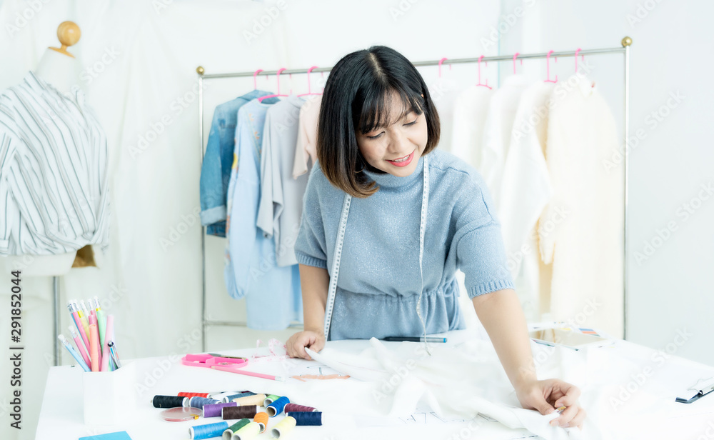 Asian designers are working at home.Attractive stylish beauty women in process of creating new clothes collection.Designers and editors are designing clothes at room Asian designers are working at home.Attractive stylish beauty women in process of creating new clothes collection.Designers and editors are designing clothes at room