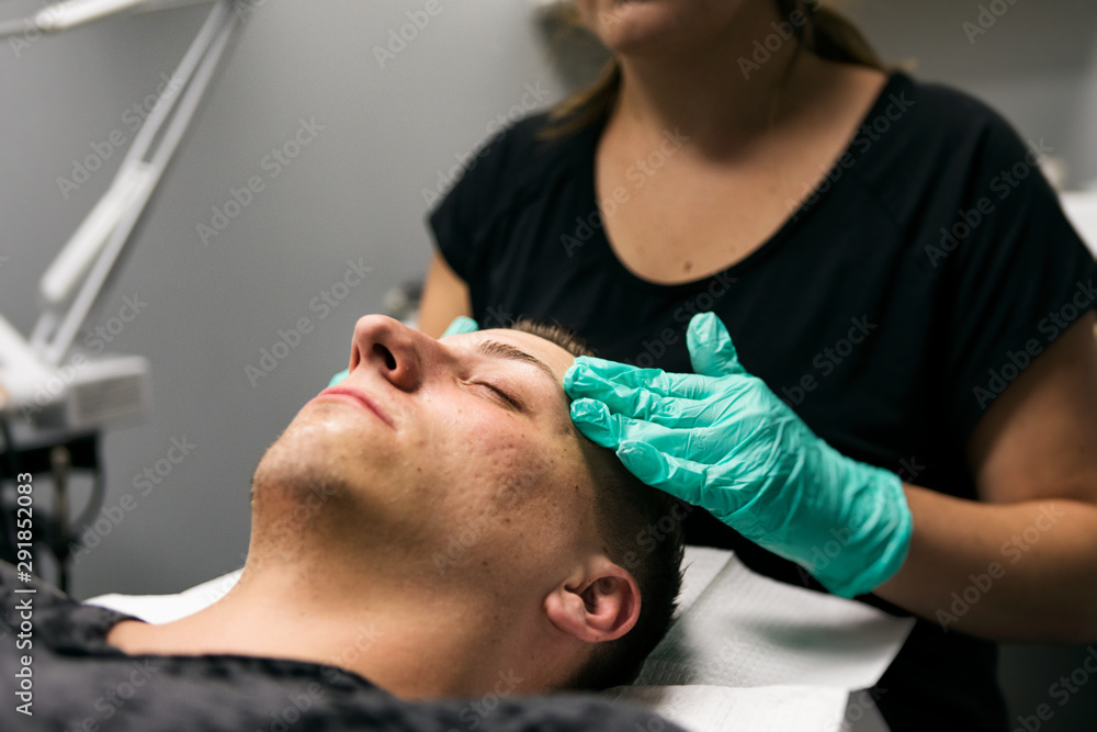Spa: Male Customer Receives Relaxing Facial During Treatment Spa: Male Customer Receives Relaxing Facial During Treatment