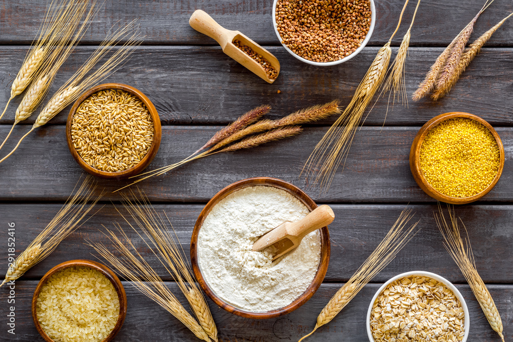 Healthy food concept. Cereals in bowls on dark wooden background top view Healthy food concept. Cereals in bowls on dark wooden background top view