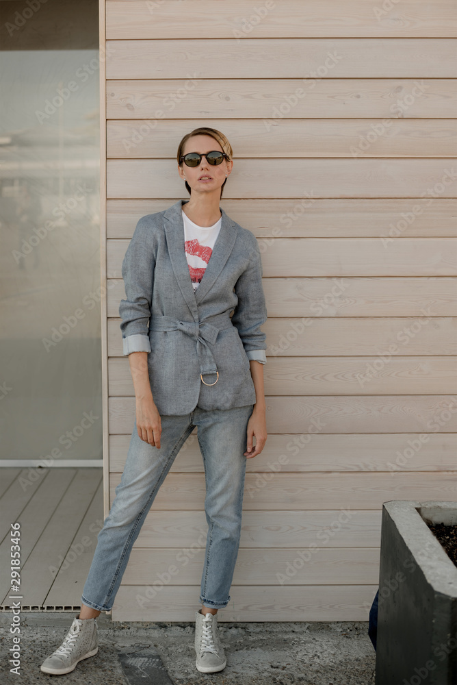 Woman standing against wooden wall Woman standing against wooden wall