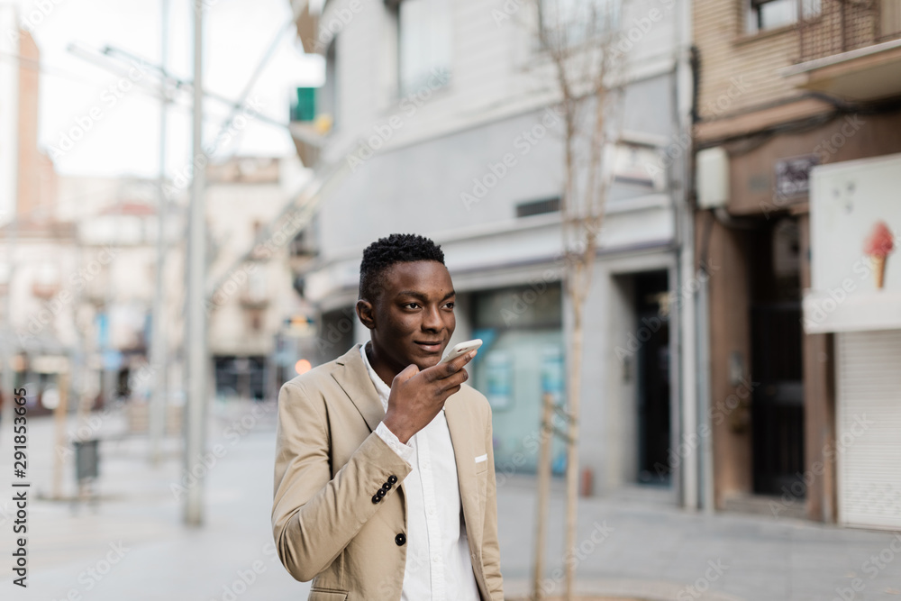 African man speaking by phone at street African man speaking by phone at street