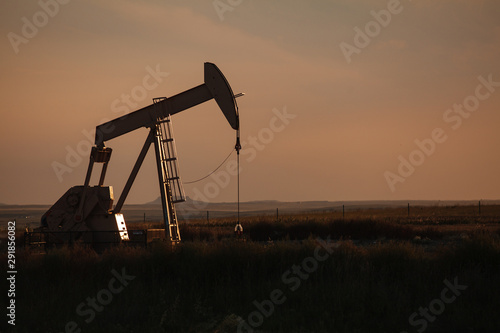 Oil derrick at dusk in North Dakota bakken. photo