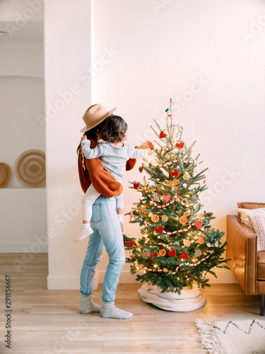 Mom and toddler in front of Christmas tree