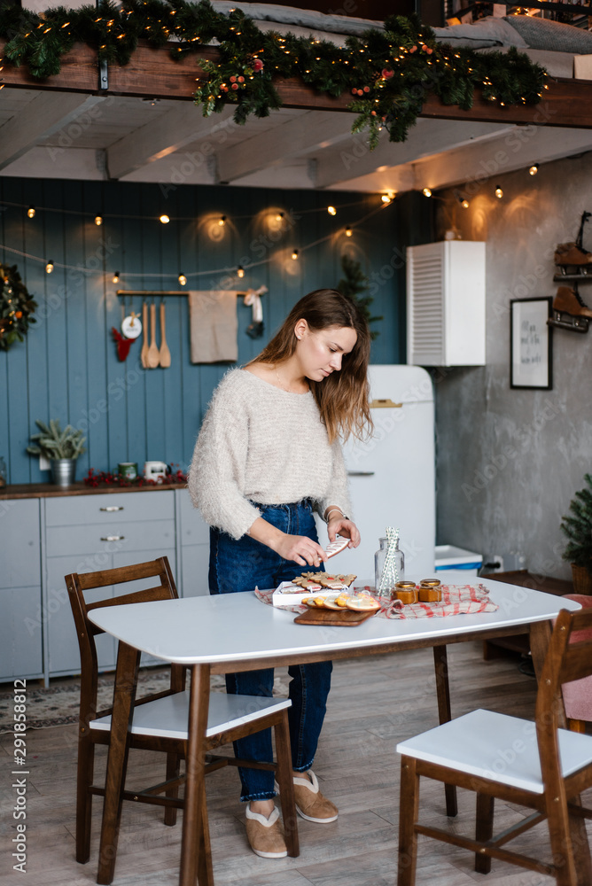 Young woman with homemade cookies at table Young woman with homemade cookies at table