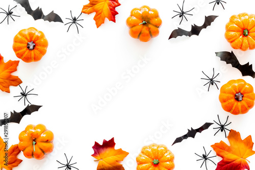 Halloween frame with pumpkins, spiders and bats on white background top view copy space