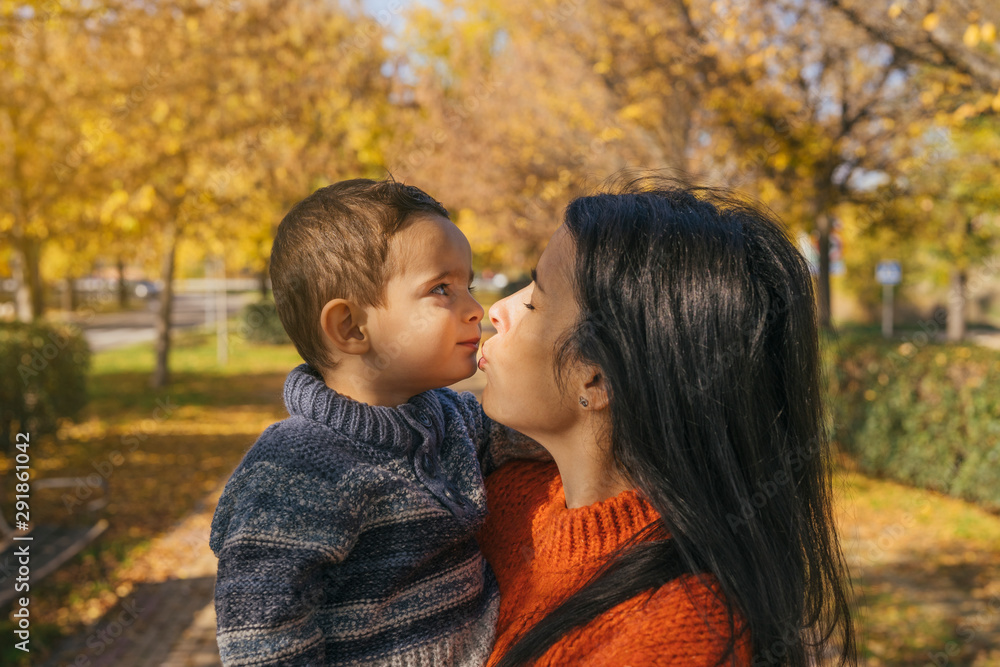 Mom and son having fun in the park Mom and son having fun in the park