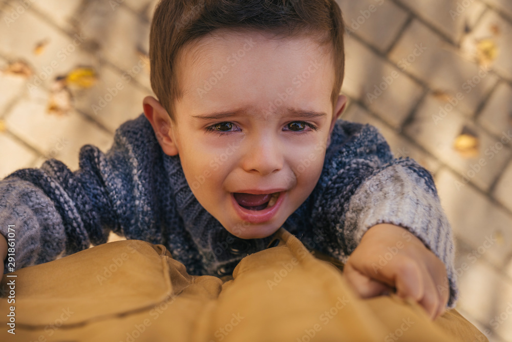 Sad cute kid alone in the park Sad cute kid alone in the park