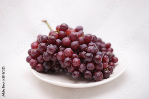 thai purple grapes with leaves isolated on white blackgound photo