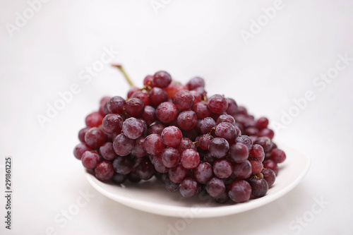 thai purple grapes with leaves isolated on white blackgound photo