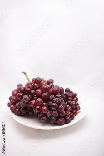 thai purple grapes with leaves isolated on white blackgound photo