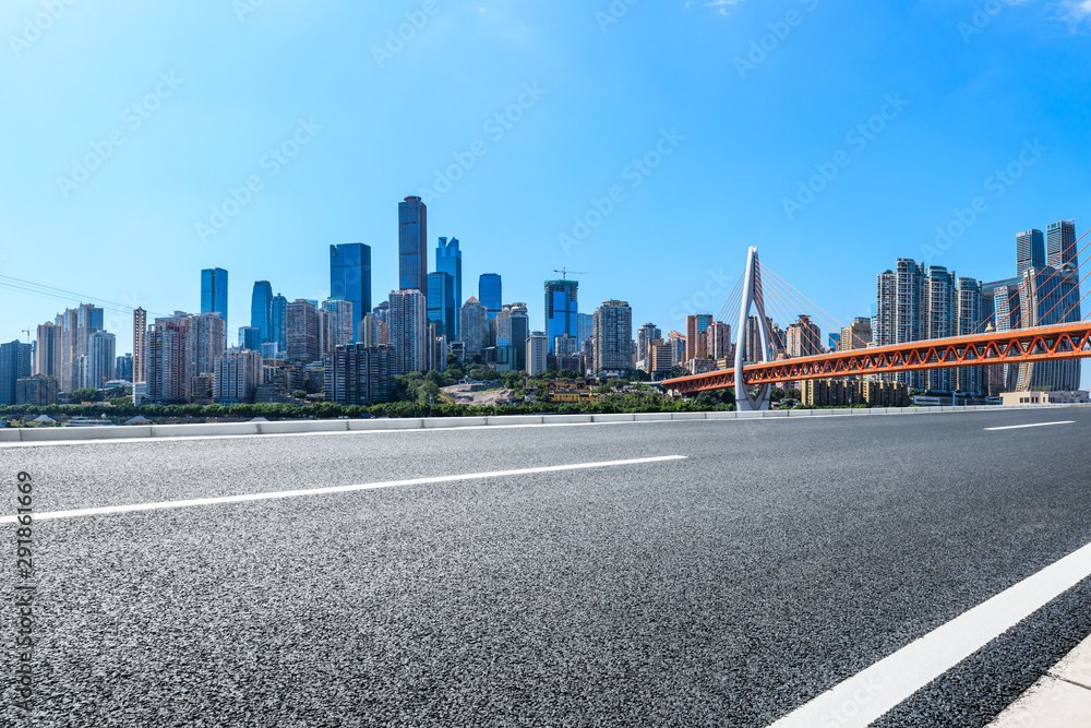 Empty asphalt road and Chongqing architectural landscape with bridge