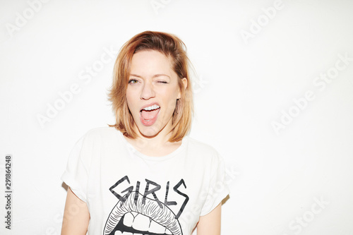 Rebel young woman blinking at camera