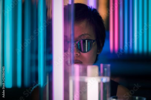 Woman wearing sunglasses standing indoors photo