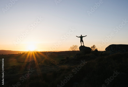 Male stood on Birchen Edge at sunset. Derbyshire, UK.
