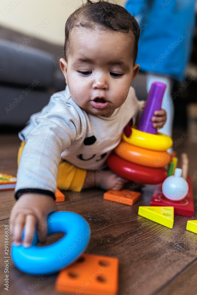 Adorable baby playing with toys at home Adorable baby playing with toys at home