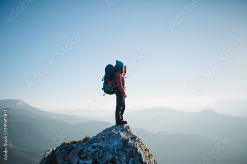 woman hiker enjoying the view from the top of the mountain
