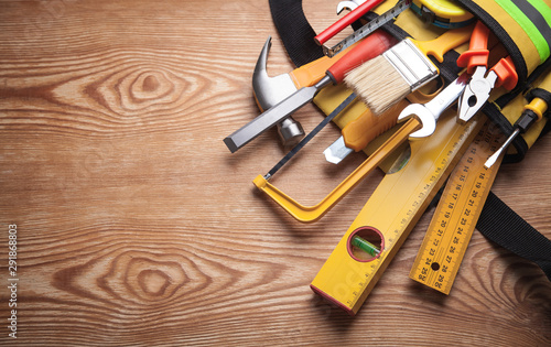 Work tools on wooden background.