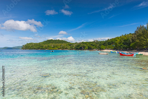 Tropical beach with clear view of water, beautiful sky