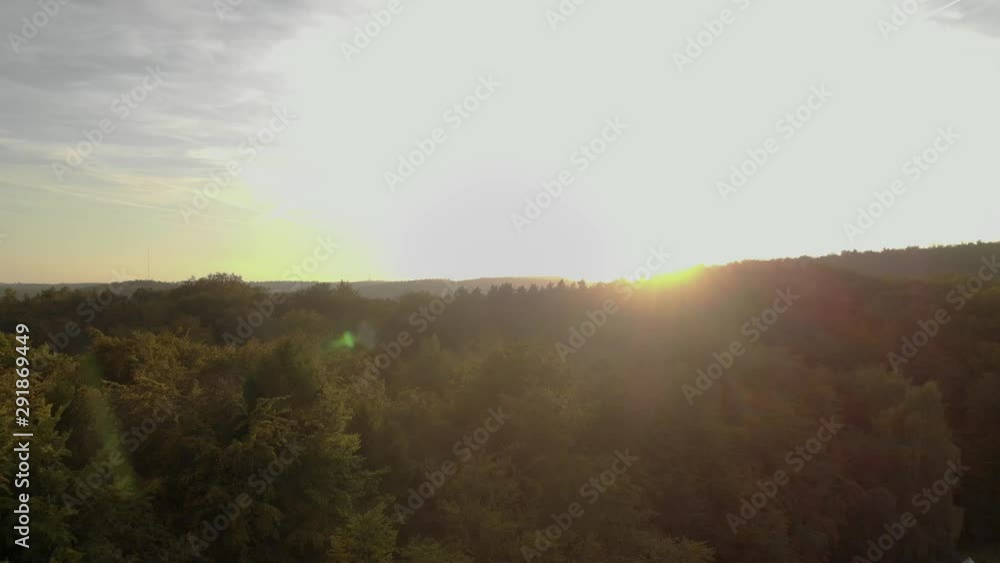 Aerial of Golden sunset at the hotizon and beautiful colorful trees in forest. Nature Scenery from the air. Aerial of Golden sunset at the hotizon and beautiful colorful trees in forest. Nature Scenery from the air.