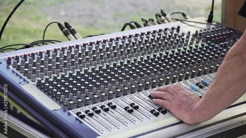 Sound mixer and hands at live concert, slowmo closeup photo