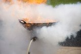 Employees demonstrated using a fire extinguisher to put out fires that are burning oil in a pan.