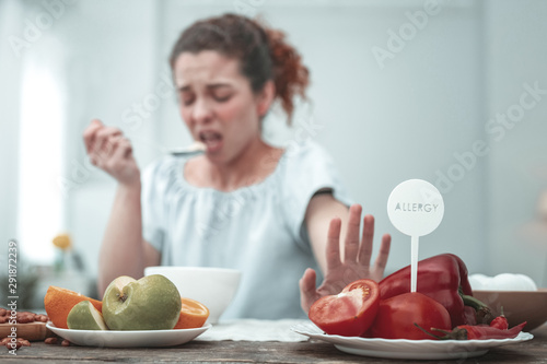 Curly woman having skin rash because of red vegetables