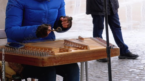 Street Musician Plays a Musical Instrument - Folk Cimbalom photo