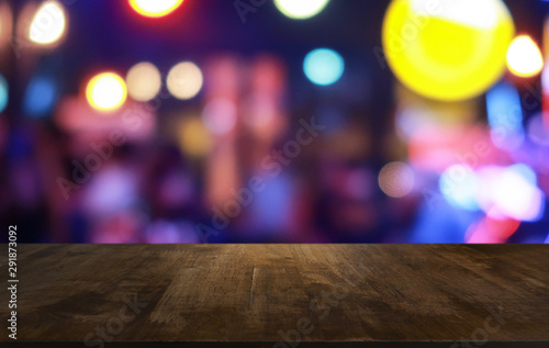 Empty dark wooden table in front of abstract blurred bokeh background of restaurant . can be used for display or montage your products.Mock up for space.