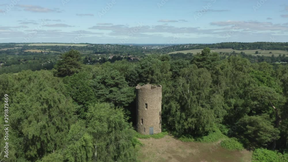 Aerial view of a English folly on the top of a hill surrounded by countryside.
Shot on a bright sunny day. Aerial view of a English folly on the top of a hill surrounded by countryside.
Shot on a bright sunny day.