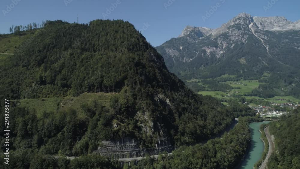 Aerial view of landscape with traffic on highway. River and traintrack next to the highway with mountains on the background and Castle on the hill Aerial view of landscape with traffic on highway. River and traintrack next to the highway with mountains on the background and Castle on the hill