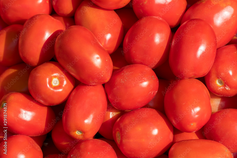 Tomato vegetables stacked on a surface as background. Tomato vegetables stacked on a surface as background.