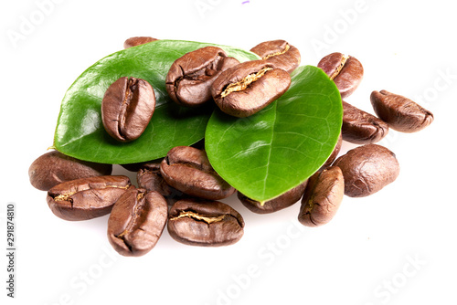 a bunch of coffee beans with green leaves on a white background, isolate. concept: freshness of coffee beans. bunch of beans