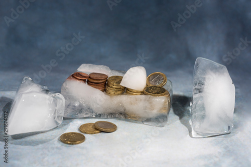 Frozen euro coins in ice. Abstract photo in banking.