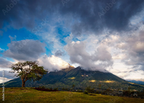 Imbabura inactive stratovolcano surrounded by stormy clouds at sunset, near Ibarra city, Imbabura Province, Ecuador