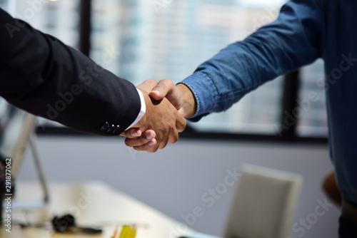 Business people making agreement and shaking hands during meeting in the office for successful dealing photo