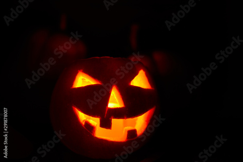 Halloween - old jack-o-lantern on black background © Alexey