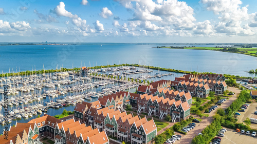 Aerial drone view of typical modern Dutch houses and marina in harbor from above, architecture of port of Volendam town, North Holland, Netherlands photo