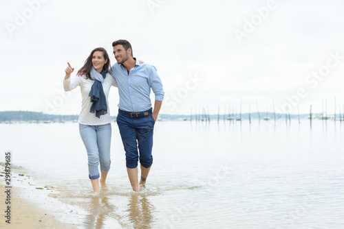 young couple walking on beach