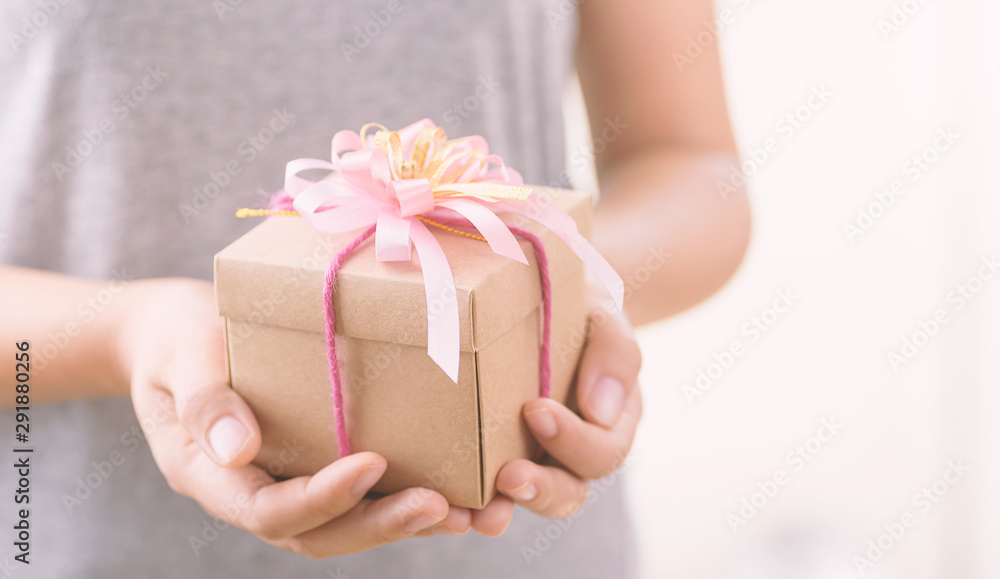 Woman holding gift box in hands for giving Woman holding gift box in hands for giving