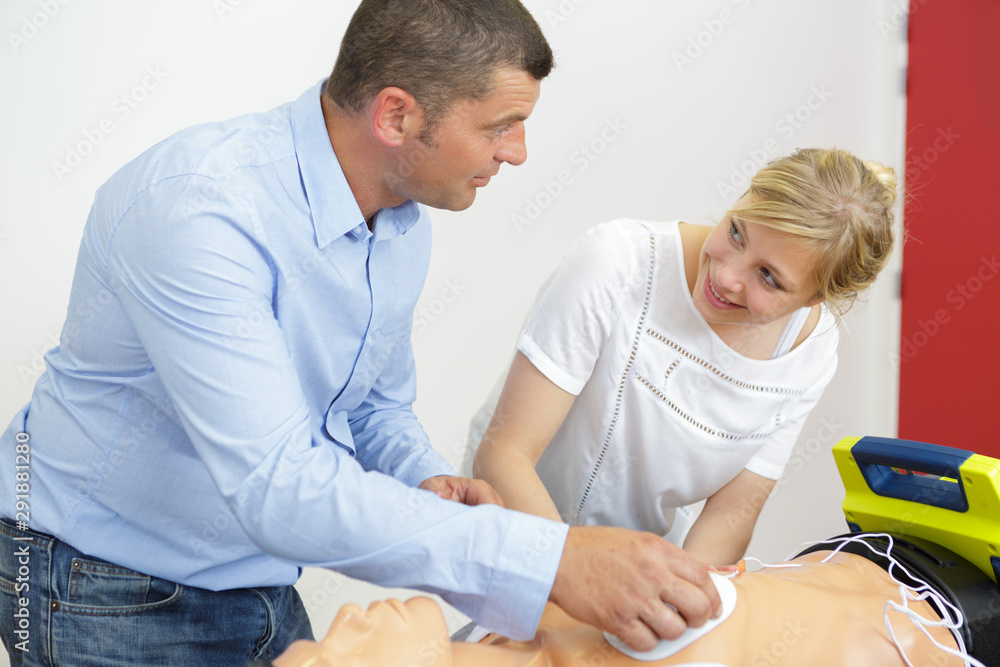 cpr practice of woman and man on cpr dummy cpr practice of woman and man on cpr dummy