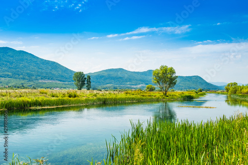 Beautiful nature landscape, Gacka river among grass banks, Lika region of Croatia