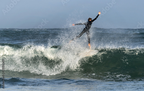 Mossel Bay, South Africa. Surfing the waves. Surfer riding wave, storm sky 