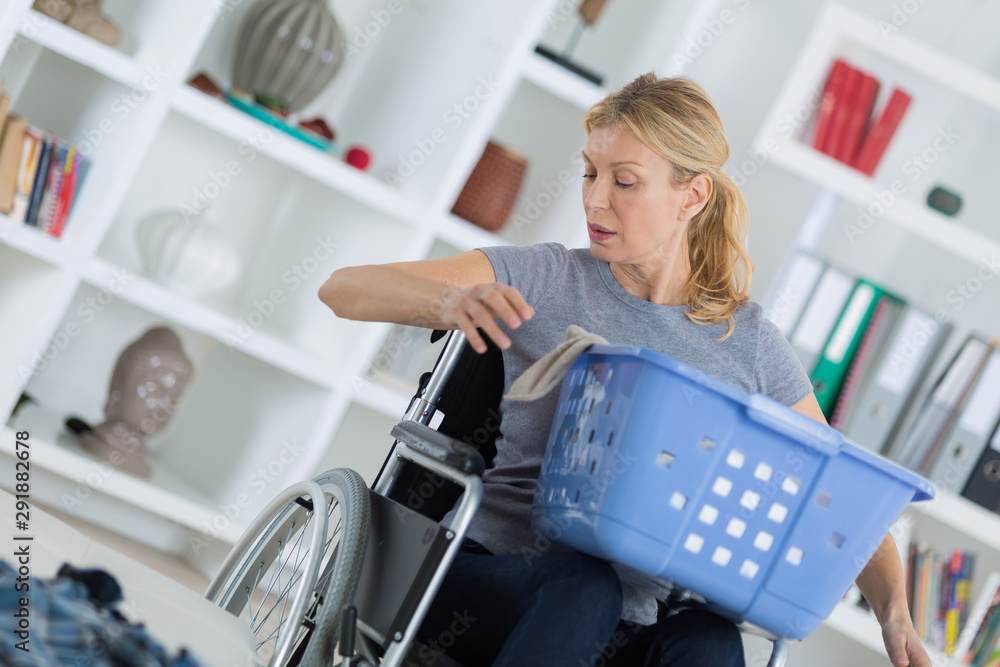 handicapped mother with laundry basket on her lap handicapped mother with laundry basket on her lap