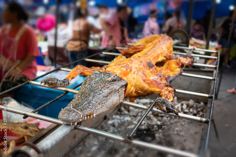 Grilled crocodile in Thai market Photos | Adobe Stock