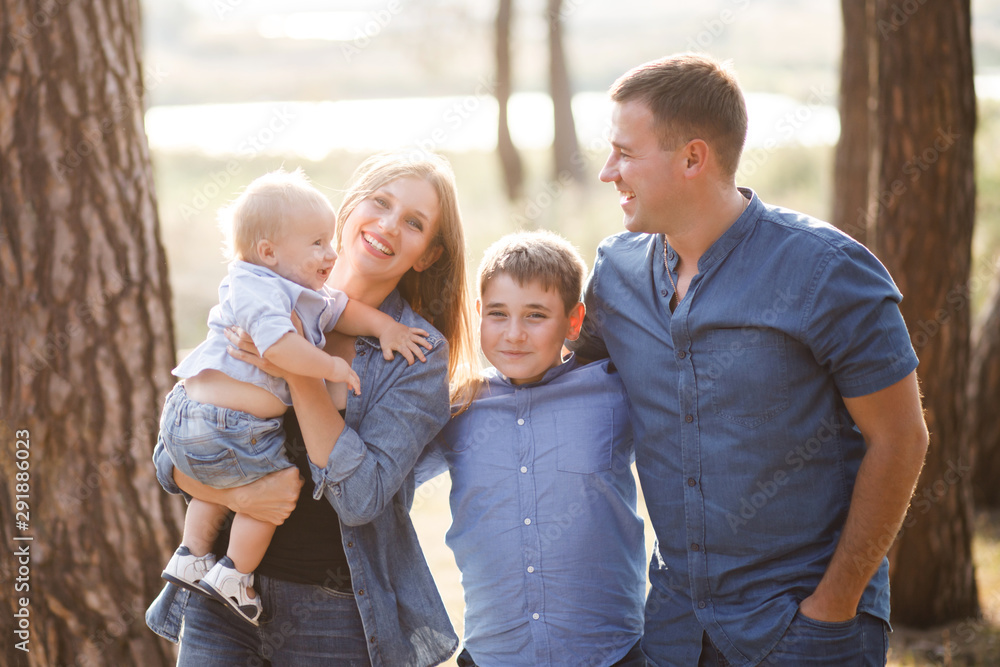 Cute young family spending time together in nature Cute young family spending time together in nature