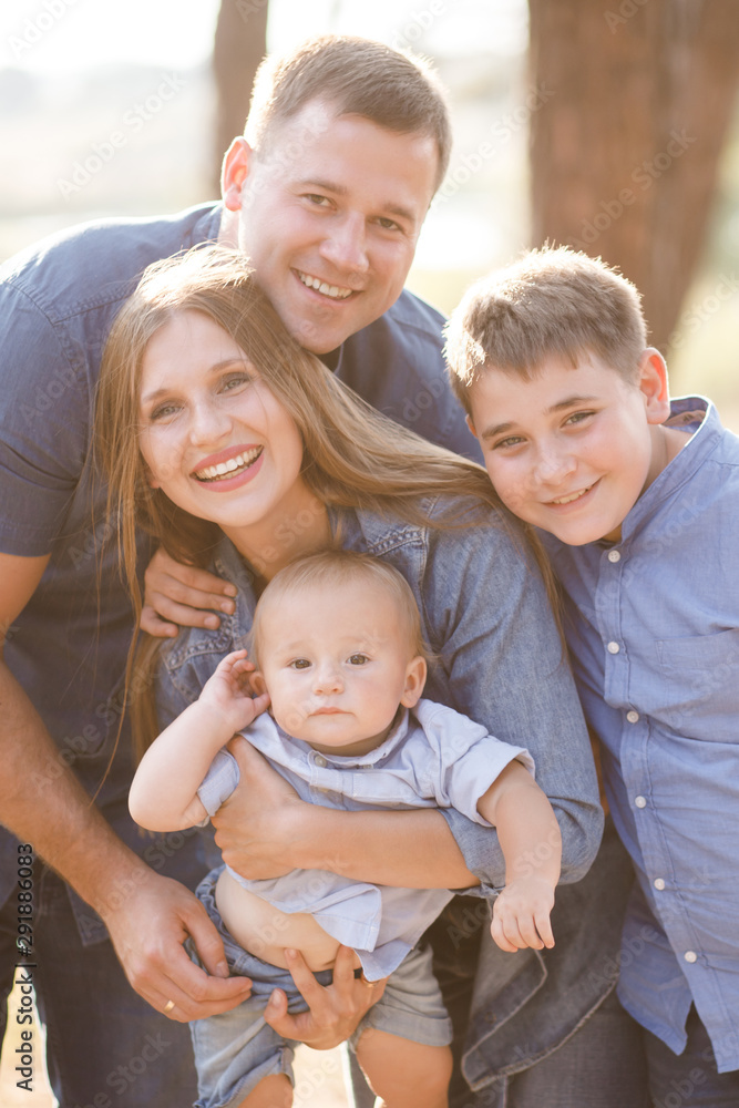 Cute young family spending time together in nature Cute young family spending time together in nature