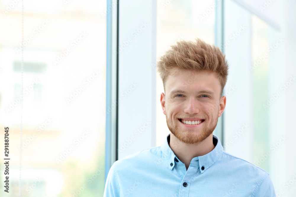 Portrait of handsome young man near window Portrait of handsome young man near window