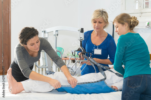 homecare nurses learning to use a hoist photo